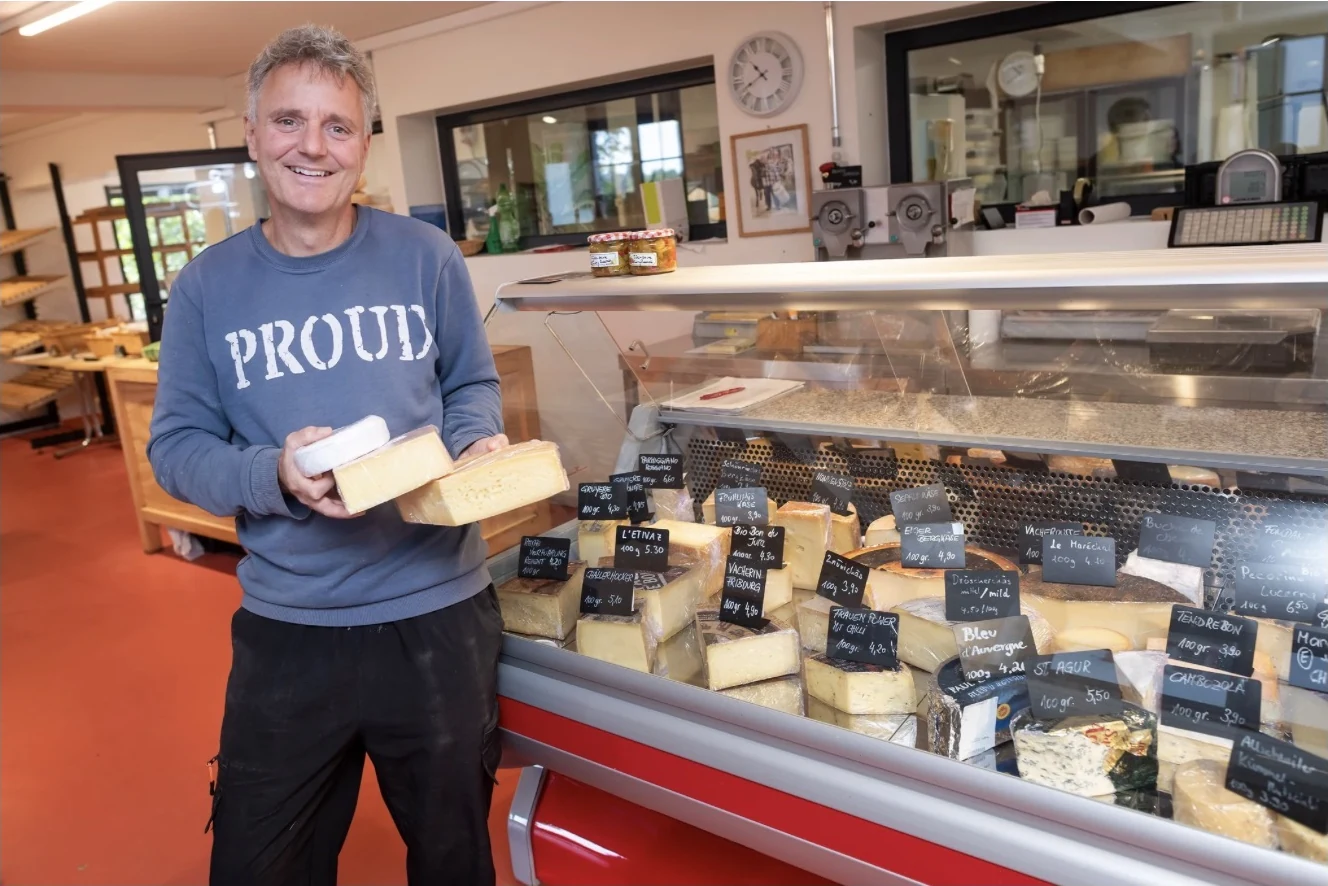 Pierre Coulin mit Käse vor der Käsetheke im neuen gemeinsamen Hofladen.